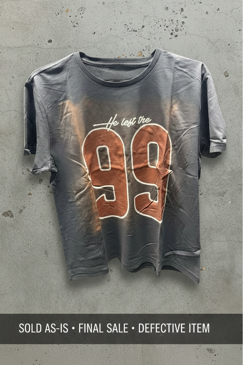 SĒK Apparel He Left the 99 Baby Tee in blue — defect unit showing print imperfection on '99' graphic, sold as-is