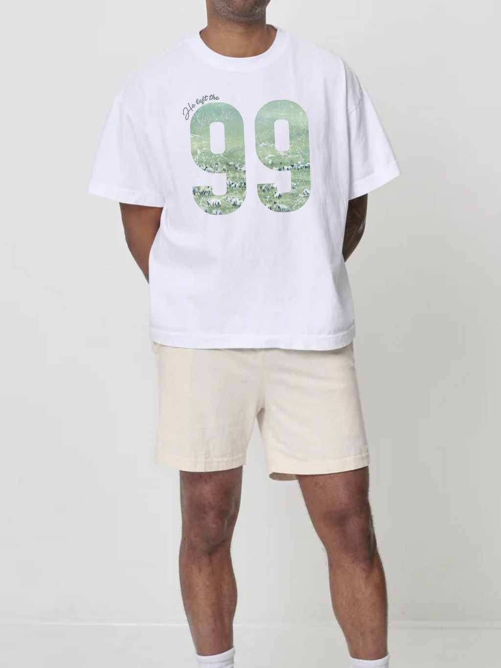 Man wearing the SĒK Apparel He Left the 99 Box Tee — Christian graphic tee with bold '99' design
