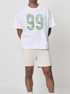 Man wearing the SĒK Apparel He Left the 99 Box Tee — Christian graphic tee with bold '99' design