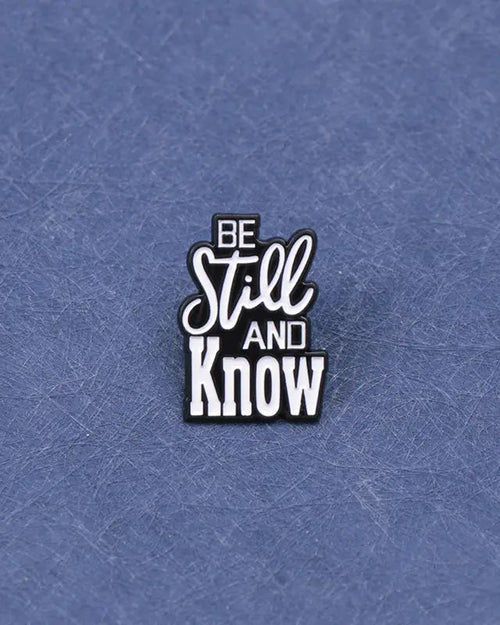 SĒK Apparel Be Still and Know enamel pin — faith-inspired Christian lapel pin with 'Be Still and Know' text referencing Psalm 46:10, front view 
