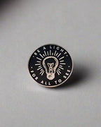 SĒK Apparel Be a Light enamel pin — gold and white Christian enamel pin with 'Be a Light' text, front view on white background
