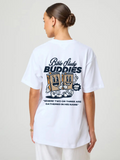 Woman wearing the SĒK Apparel Bible Study Buddies Tee — back view of white oversized Christian tee with 'Bible Study Buddies' graphic print