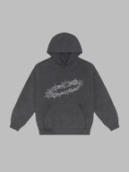 SĒK Apparel By His Wounds Hoodie in washed black — flat lay front view with crown of thorns graphic, faith-inspired Christian pullover hoodie