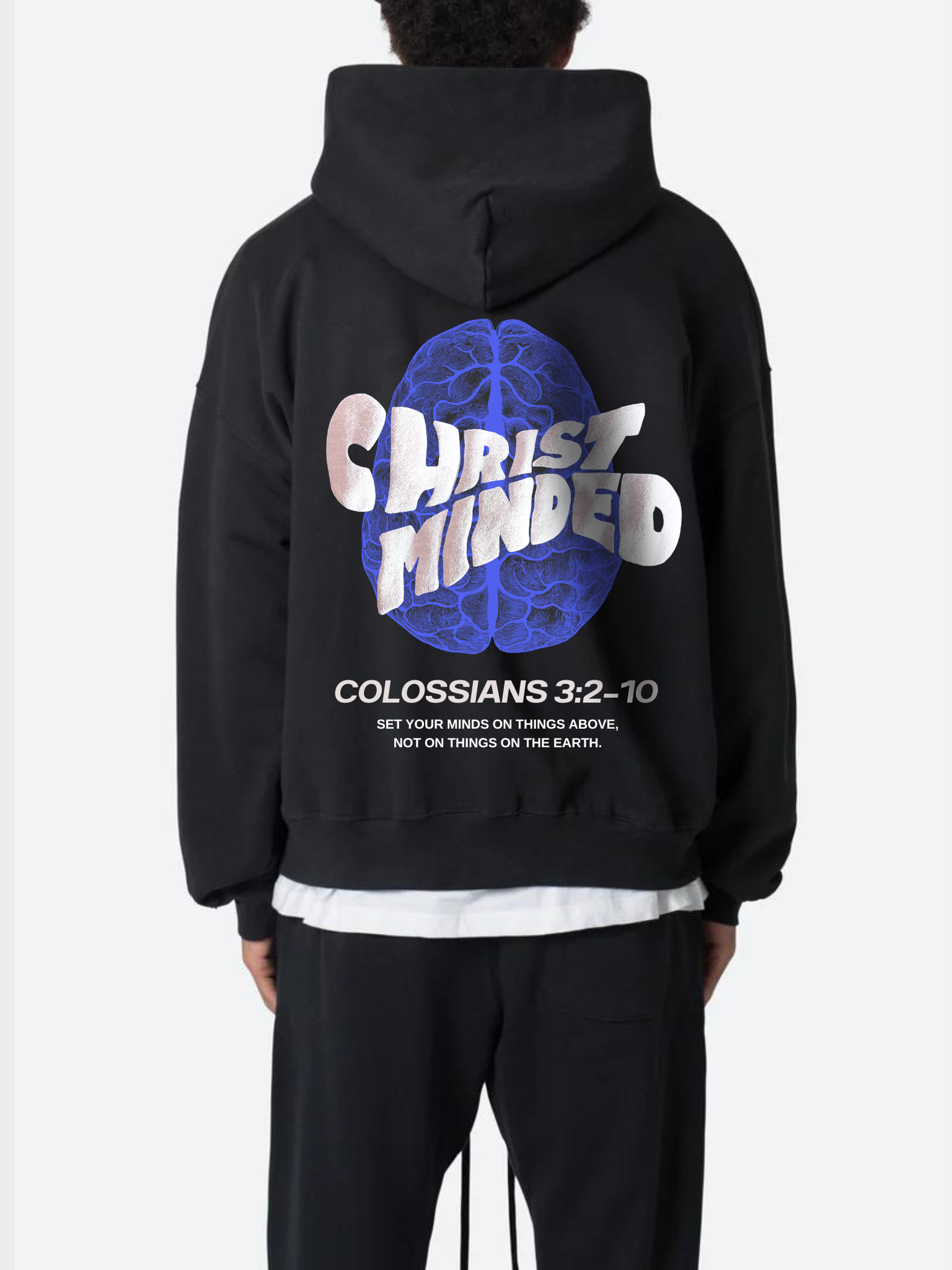 Man wearing the SĒK Apparel Christ-Minded Hoodie in black — back view with 'Christ-Minded' Colossians 3:2-4 scripture graphic