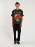 Man wearing the SĒK Apparel Hebrews 12:29 Vintage Tee — front view of 'Consuming Fire' Christian graphic tee with vintage distressed print