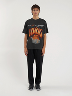 Man wearing the SĒK Apparel Hebrews 12:29 Vintage Tee — front view of 'Consuming Fire' Christian graphic tee with vintage distressed print