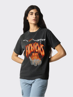 Woman wearing the SĒK Apparel Hebrews 12:29 Vintage Tee — 'Consuming Fire' faith-inspired Christian graphic tee in vintage washed style