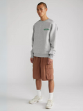Man wearing the SĒK Apparel Endless Mercies Crewneck in heather gray — front view of premium faith-inspired Christian sweatshirt with embroidered 'Endless Mercies' detail, referencing Lamentations 3:22-23