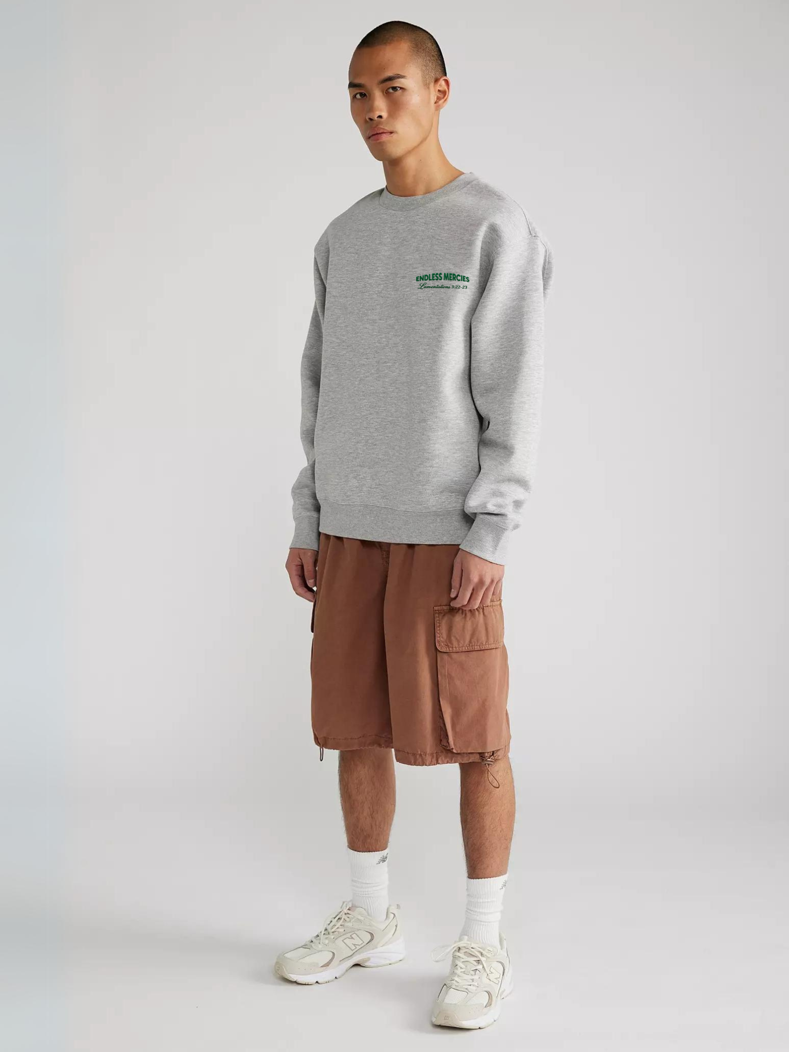 Man wearing the SĒK Apparel Endless Mercies Crewneck in heather gray — front view of premium faith-inspired Christian sweatshirt with embroidered 'Endless Mercies' detail, referencing Lamentations 3:22-23