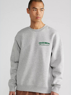 Man wearing the SĒK Apparel Endless Mercies Crewneck in heather gray — front view of premium faith-inspired Christian sweatshirt with embroidered 'Endless Mercies' detail, referencing Lamentations 3:22-23