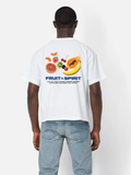 Man wearing the SĒK Apparel Fruit of the Spirit Box Tee in white — back view with fruit illustration and 'Fruit of the Spirit' Galatians 5:22 graphic