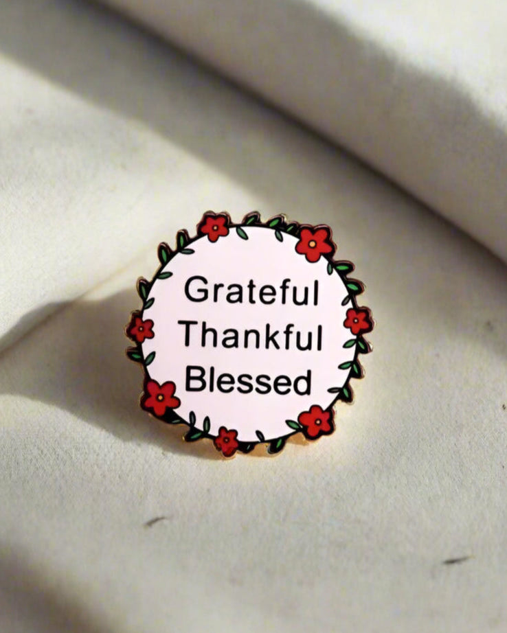 SĒK Apparel Grateful, Thankful, Blessed enamel pin — round floral Christian lapel pin with 'Grateful Thankful Blessed' text, faith-inspired accessory