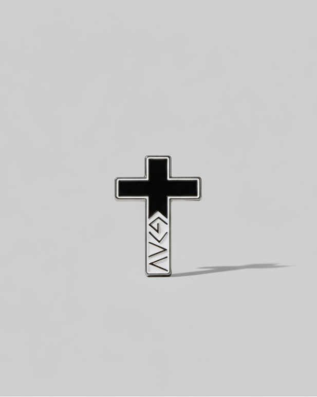 SĒK Apparel God is Greater Than the Highs and Lows enamel pin — cross-shaped Christian lapel pin with 'G>∧∨' symbol, faith-inspired accessory