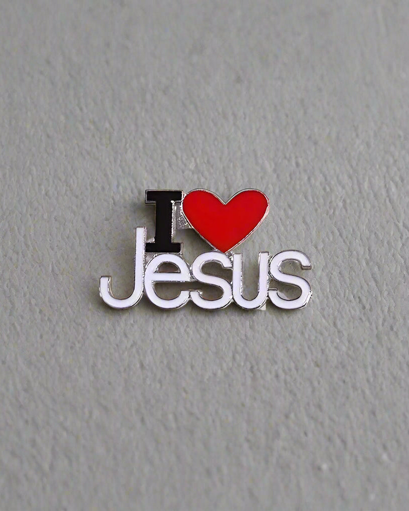 SĒK Apparel I Love Jesus enamel pin — white pin with 'I ❤️ JESUS' text and red heart symbol, faith-inspired Christian lapel pin