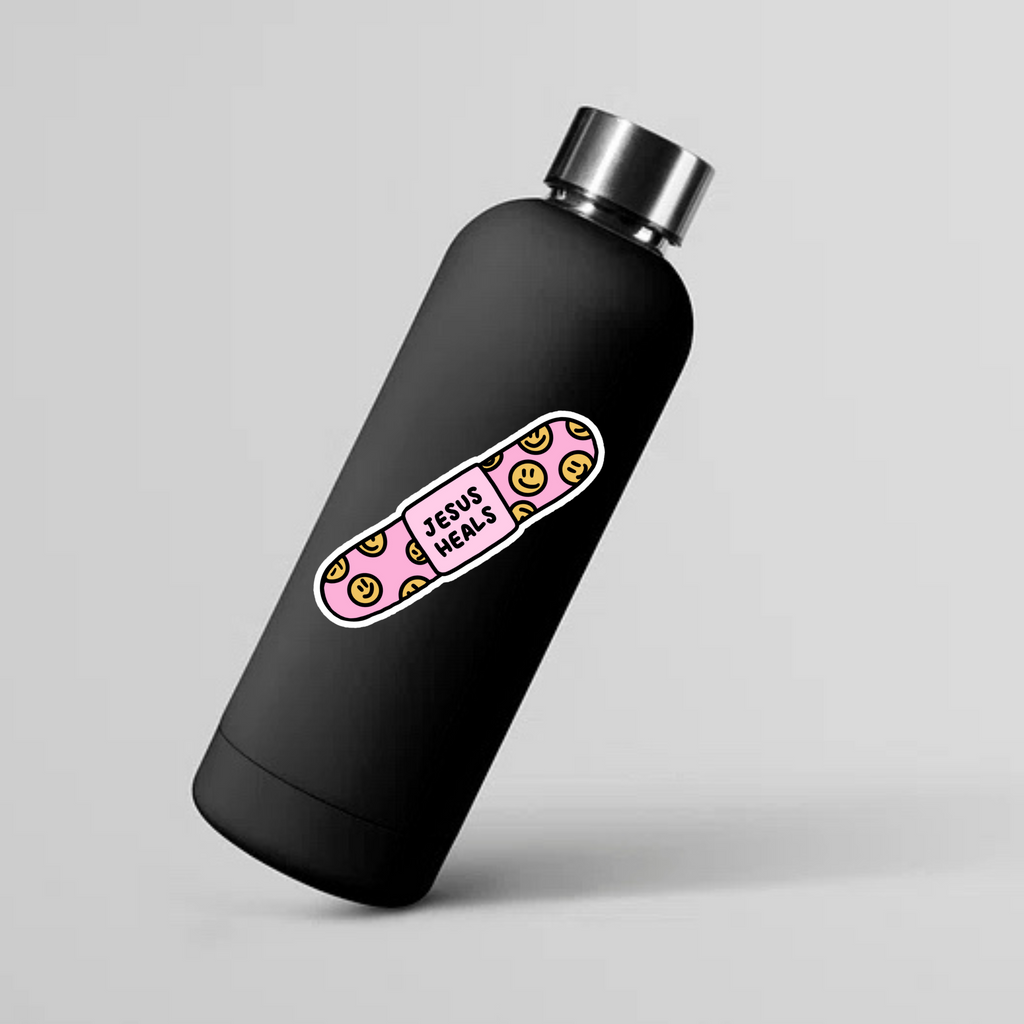 SĒK Apparel Jesus Heals bandaid sticker shown on a water bottle mockup — faith-inspired Christian sticker perfect for bottles, laptops, and journals