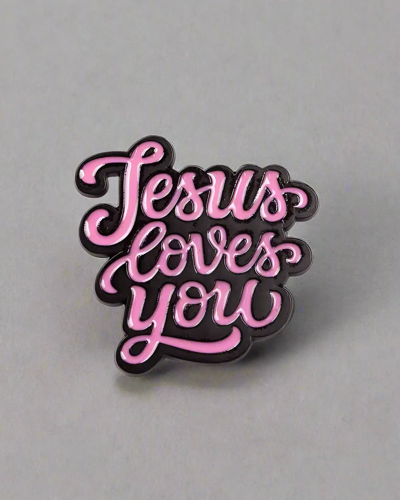 SĒK Apparel Jesus Loves You enamel pin — pink pin with 'JESUS LOVES YOU' in cursive letters, faith-inspired Christian lapel pin