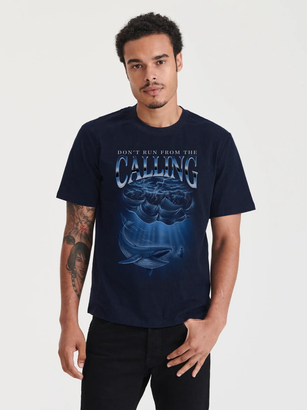 Man wearing the SĒK Apparel Jonah Vintage Tee in navy — front view of faith-inspired Christian vintage graphic tee with Jonah and the whale design, referencing Jonah 1-2