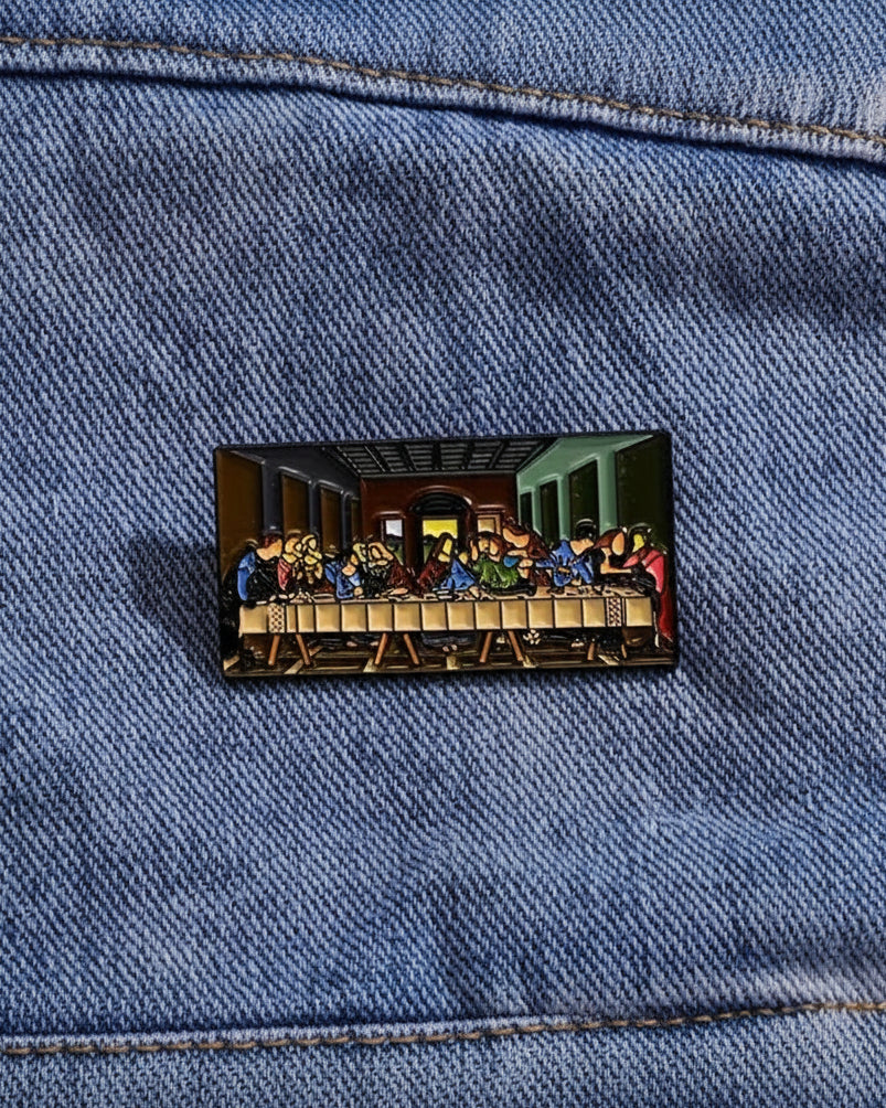 SĒK Apparel Last Supper enamel pin —shown pinned to denim fabric