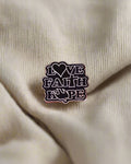 SĒK Apparel Love Faith Hope enamel pin — faith-inspired Christian lapel pin with 'Love Faith Hope' text, referencing 1 Corinthians 13:13