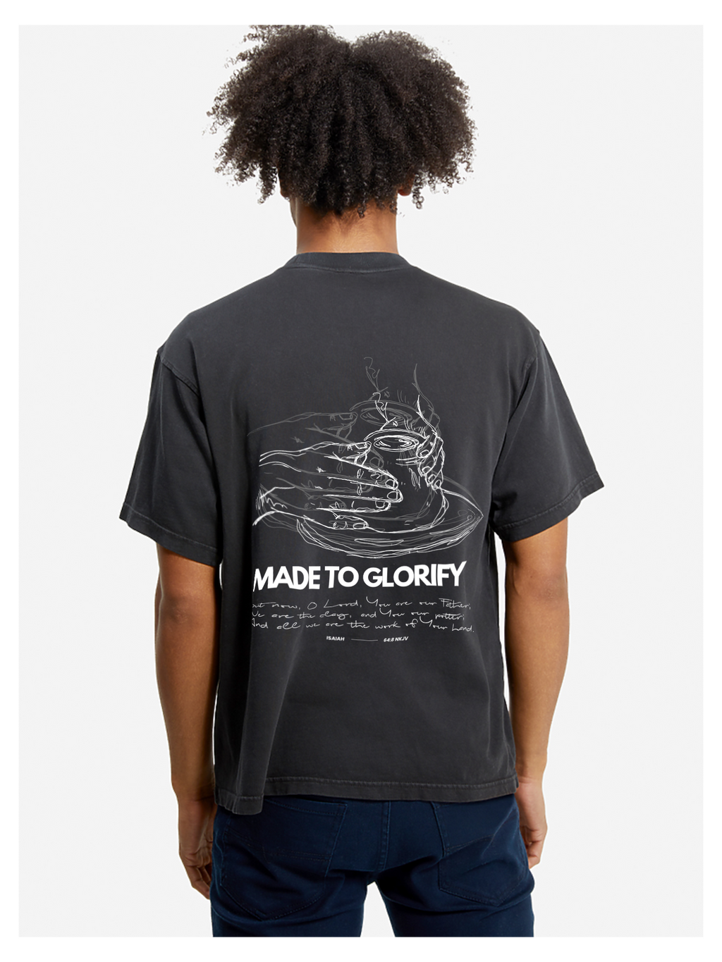 Man wearing the SĒK Apparel Made to Glorify Tee in faded black — back view with bold 'Made to Glorify' text, faith-inspired Christian graphic tee