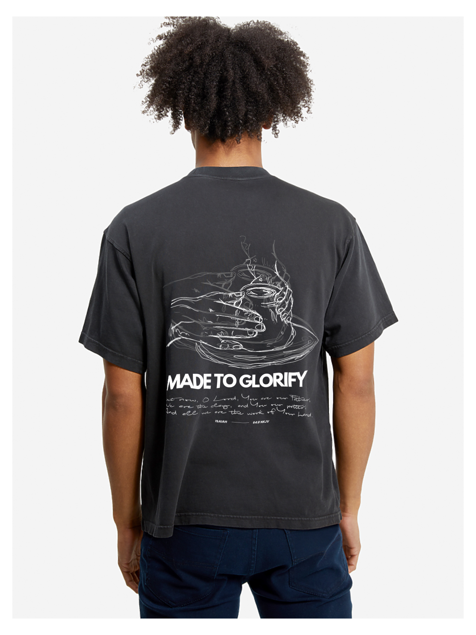 Man wearing the SĒK Apparel Made to Glorify Tee in faded black — back view with bold 'Made to Glorify' text, faith-inspired Christian graphic tee