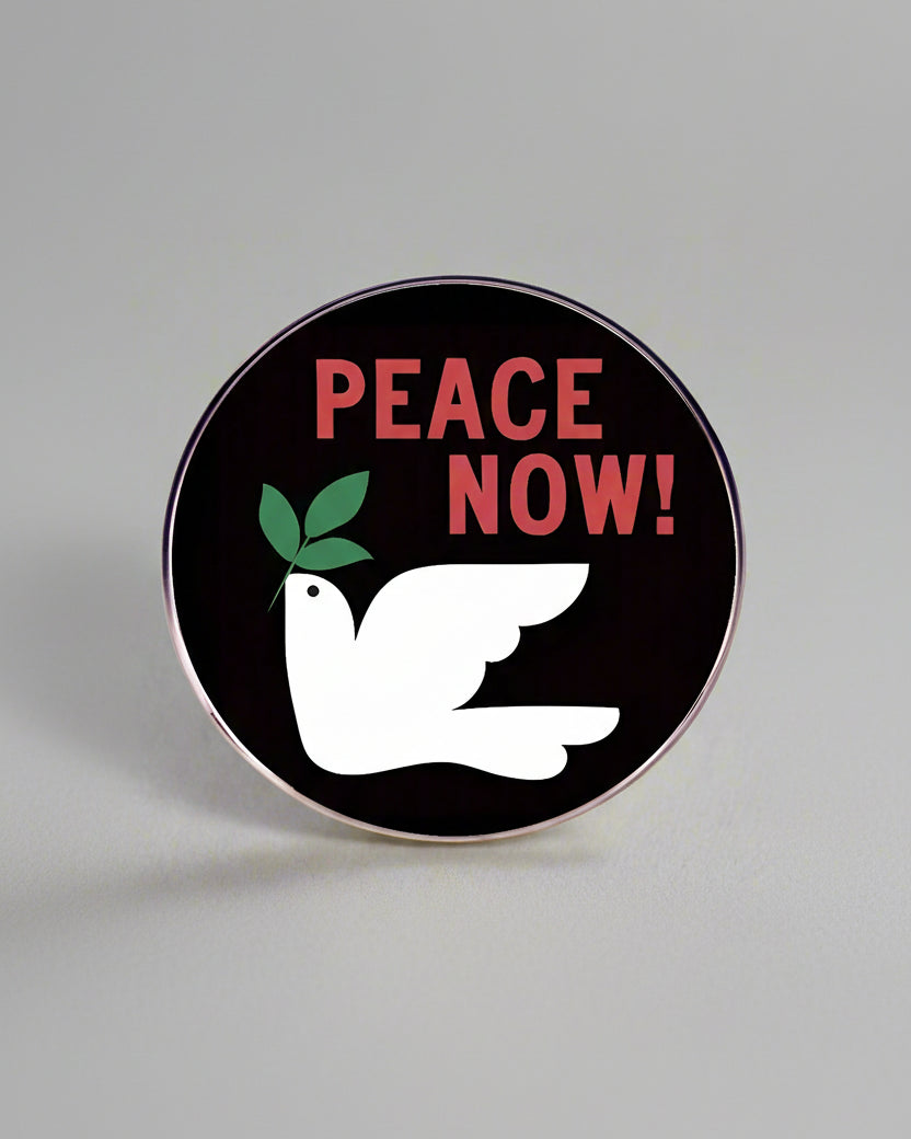 SĒK Apparel Peace Now enamel pin — black pin with white dove and bold 'Peace Now!' text in red, faith-inspired Christian lapel pin referencing John 14:27