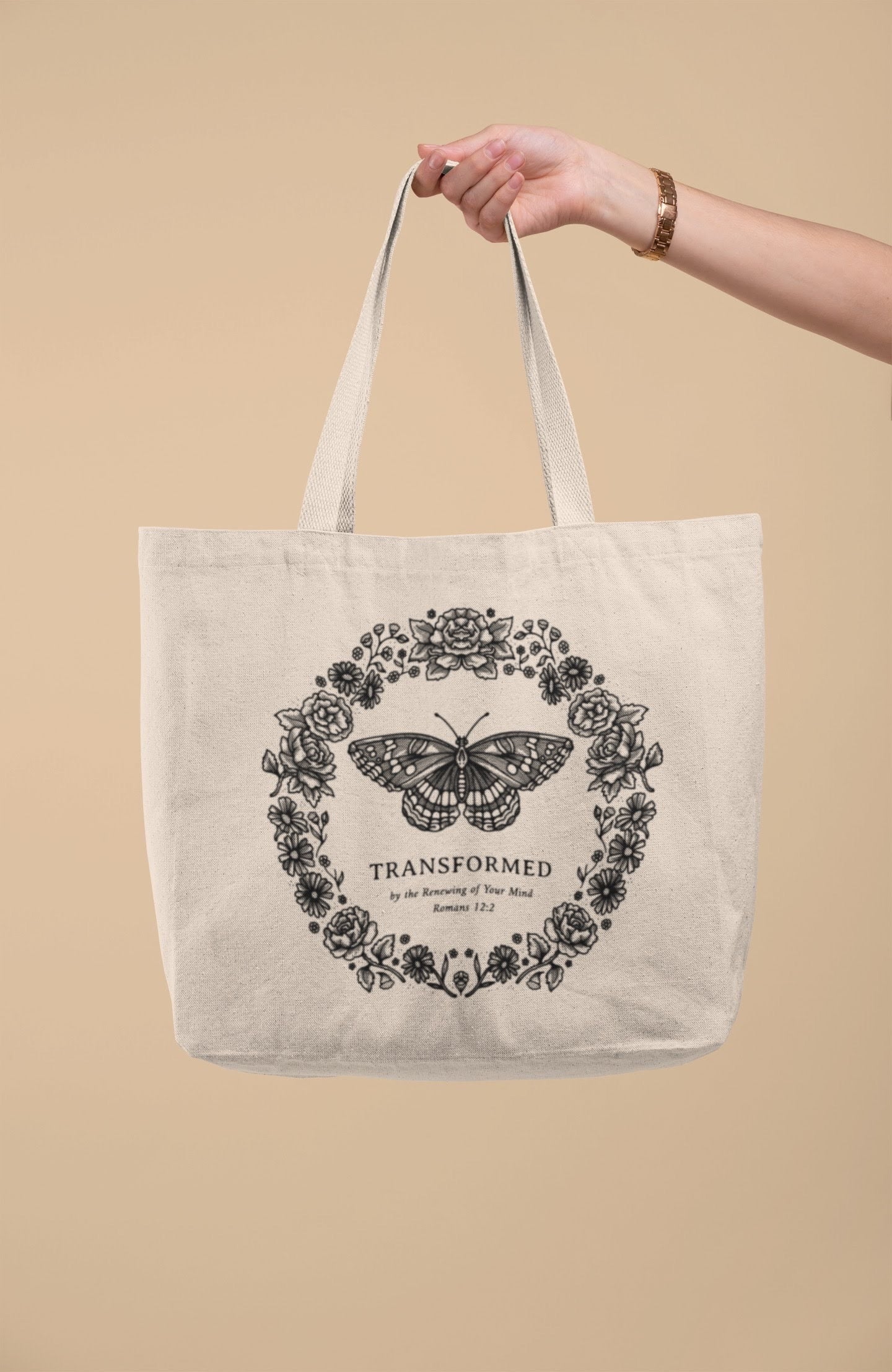 SĒK Apparel Transformed Butterfly Tote — product shot of faith-inspired Christian canvas tote bag with butterfly design and 'Transformed' text, referencing Romans 12:2