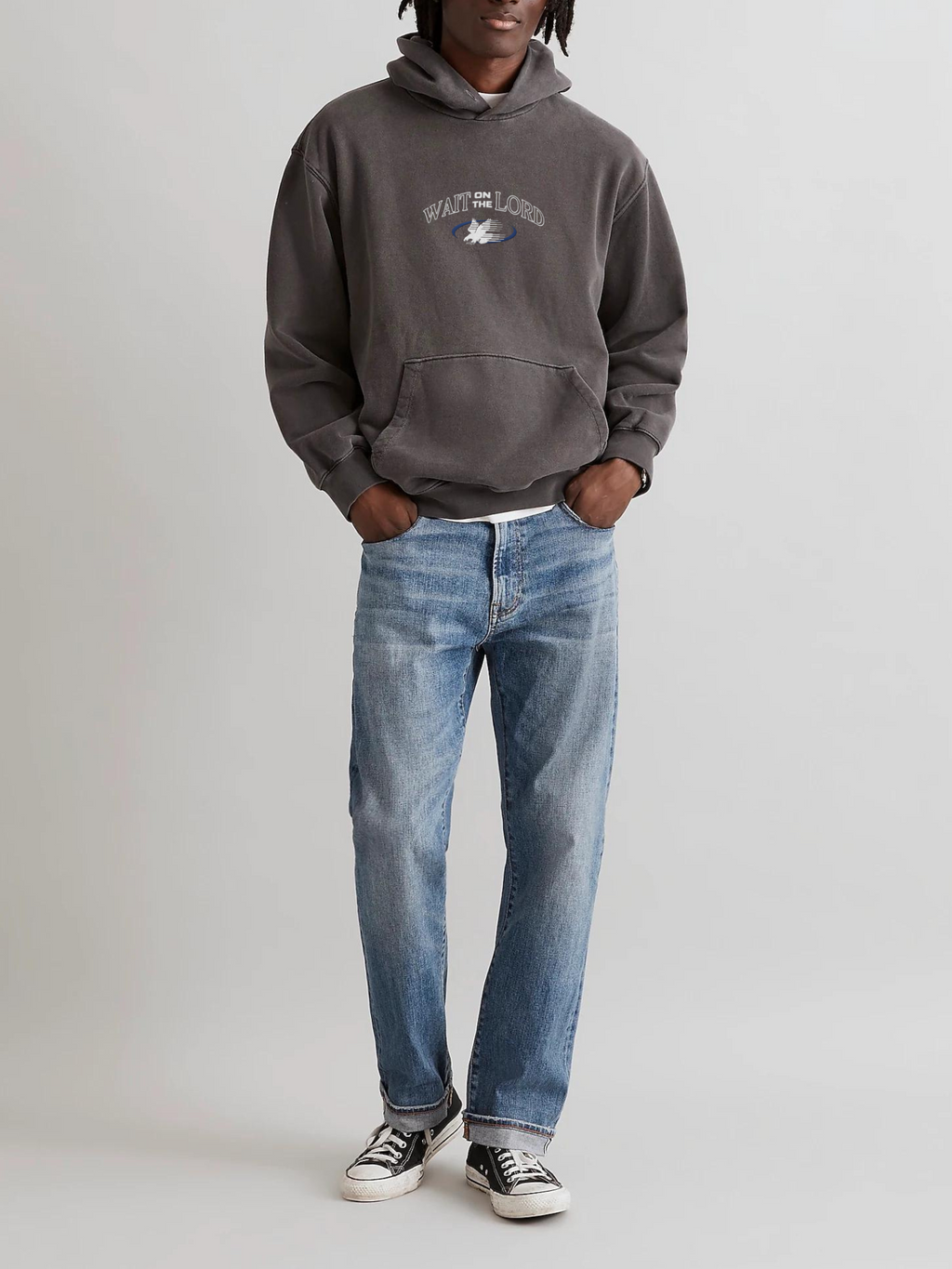 Model wearing SĒK Apparel Wait on the Lord Hoodie in gray with blue jeans and white sneakers — Isaiah 40:31 Christian hoodie