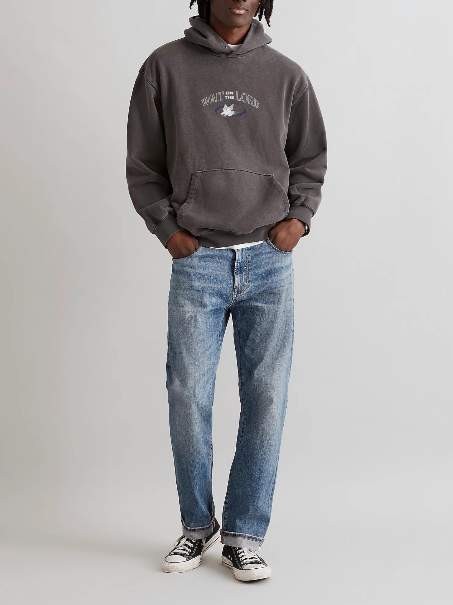 Model wearing SĒK Apparel Wait on the Lord Hoodie in gray with blue jeans and white sneakers — Isaiah 40:31 Christian hoodie