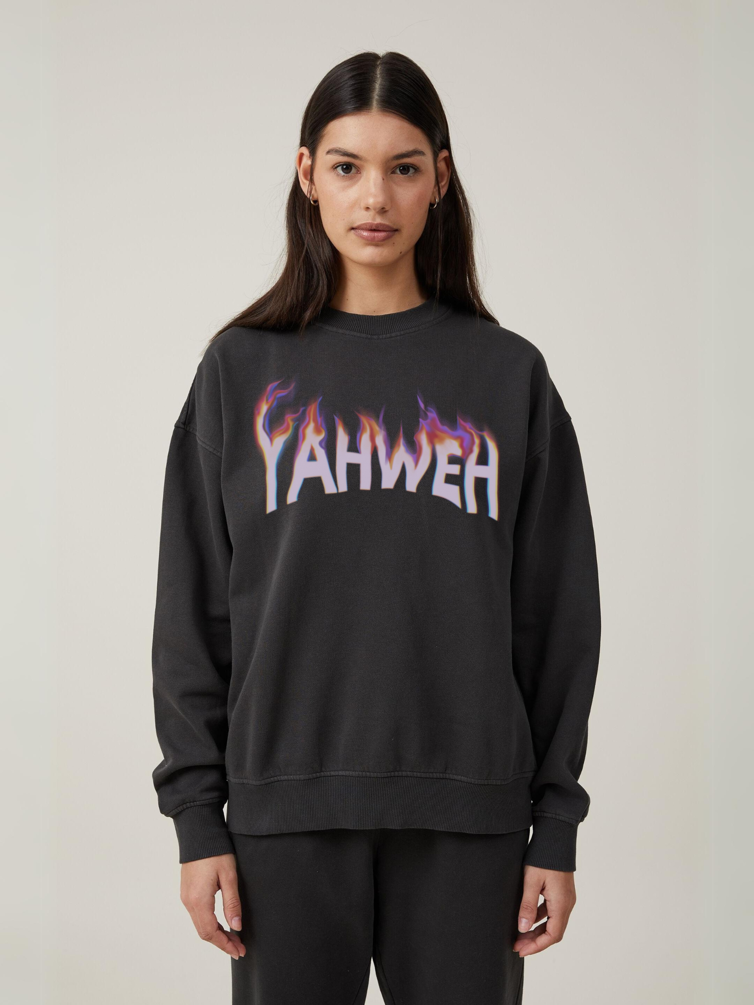 Woman wearing the SĒK Apparel YAHWEH Crewneck in gray — faith-inspired Christian sweatshirt with bold 'YAHWEH' text