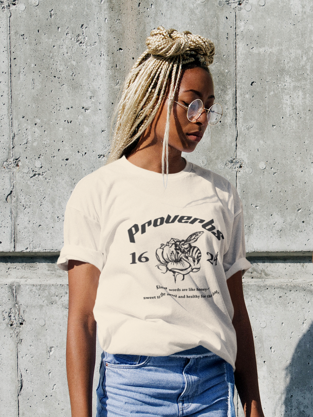 Woman wearing the SĒK Apparel Proverbs 16:24 Graphic Tee — front view of faith-inspired Christian graphic tee with honey illustration and Proverbs 16:24 scripture design