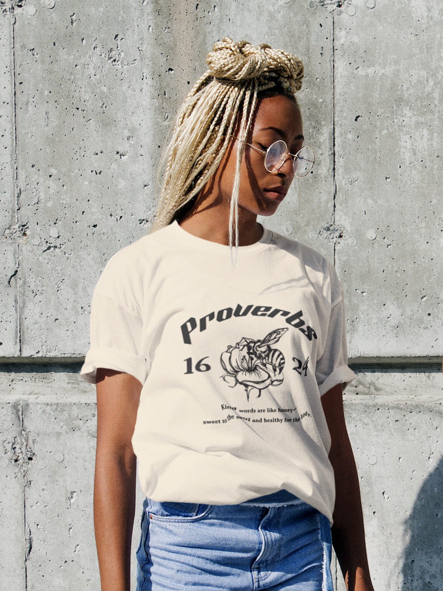 Woman wearing the SĒK Apparel Proverbs 16:24 Graphic Tee — front view of faith-inspired Christian graphic tee with honey illustration and Proverbs 16:24 scripture design